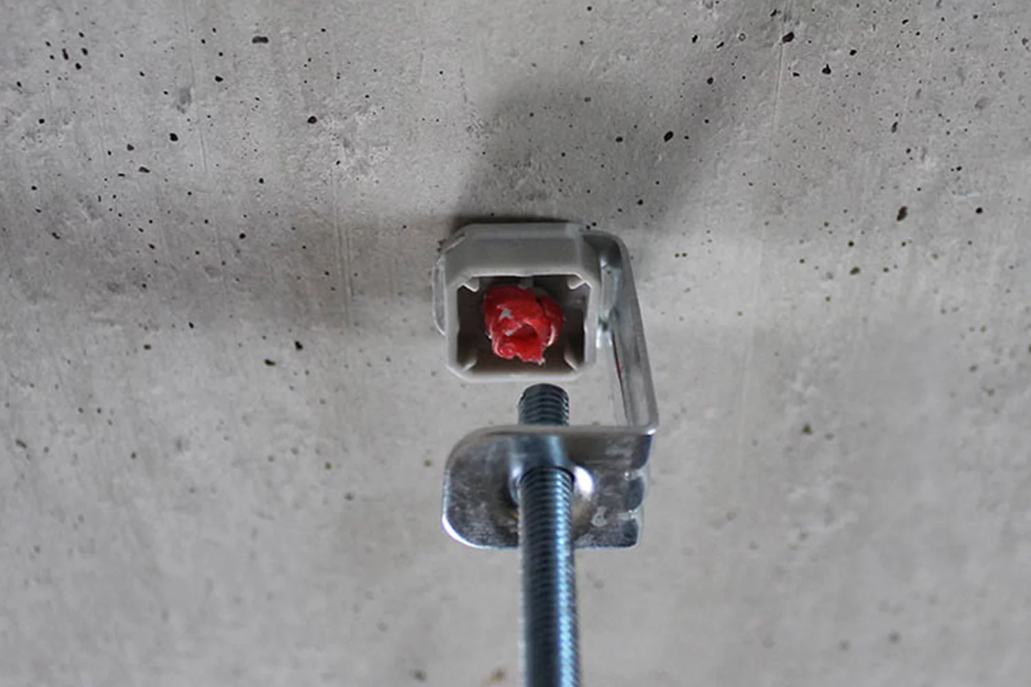 The ATV threaded rod hanger nailed to a ceiling with an XHA nail and the FORCE ONE+ nailer