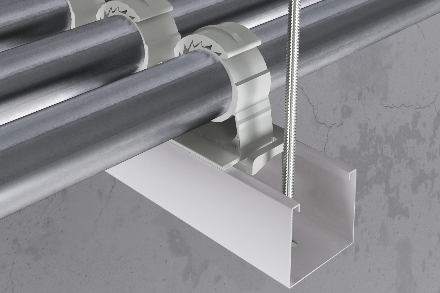 Three pipes fixed to a suspended strut channel with the SSC Smart Strut Clamp