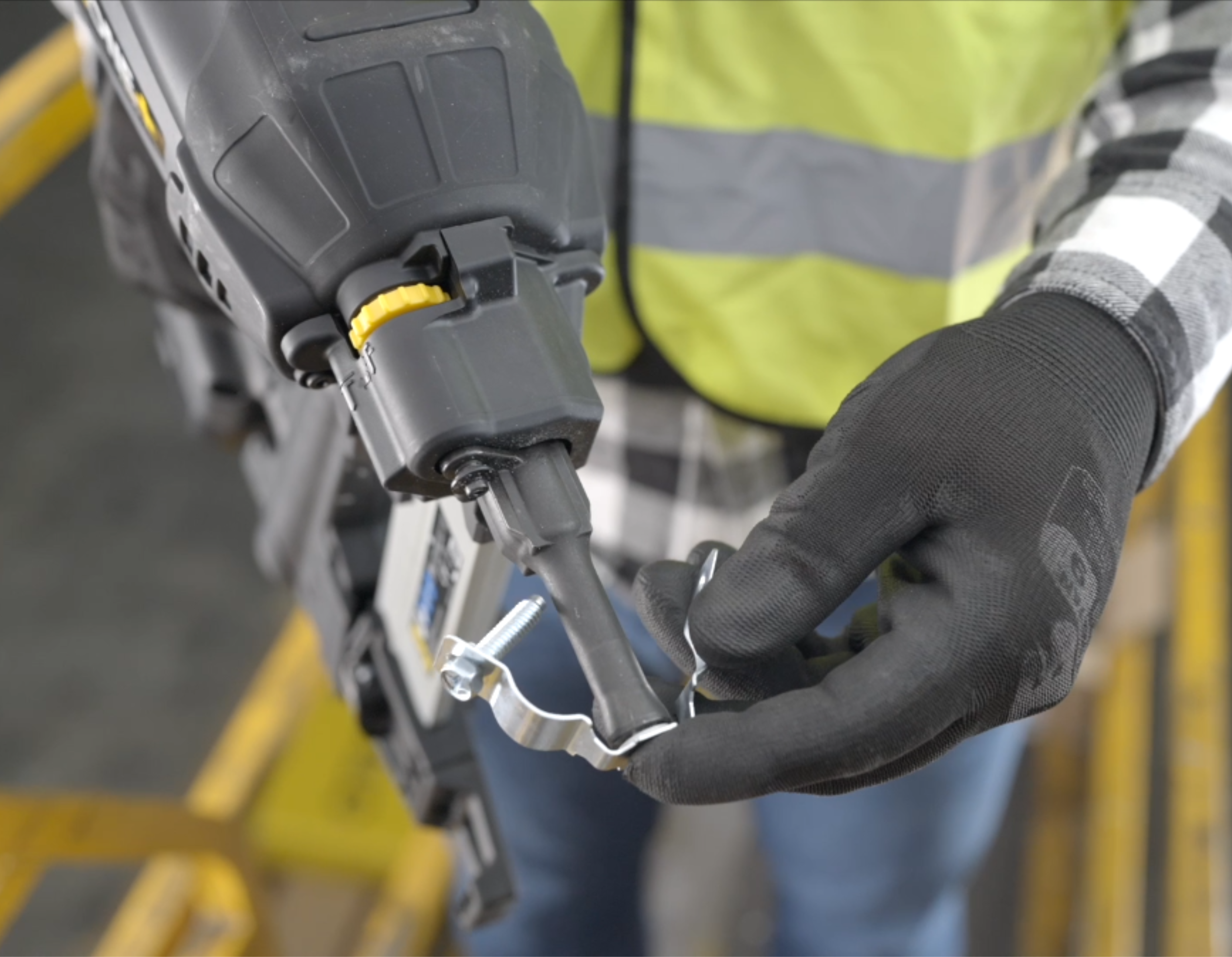 The CCM metal clamp being attached to the nose of the FORCE ONE+ nailer